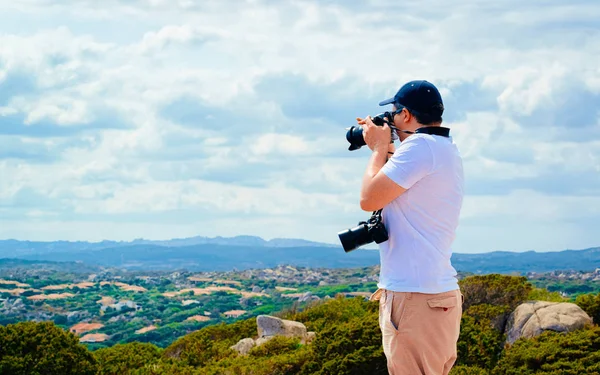 Man med kamera vid klipporna på Capo Testa Medelhavet reflex — Stockfoto