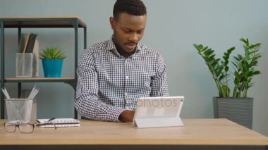 Tablet bilgisayar cihaz ile ofiste çalışan ABD'li iş adamı