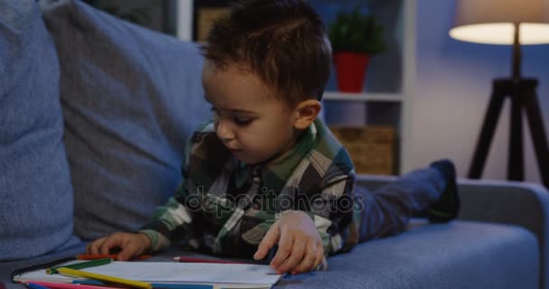 Schoolboy in glasses reading a book — Stock Video