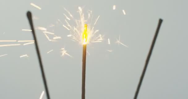 Close up of the three sparklers burning on the white background. Macro — Stock Video