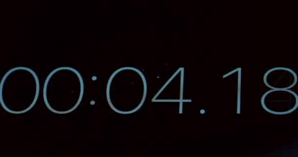 Macro of the timer counting seconds from 0 to 26 on the black screen. Close up. — Stock Video