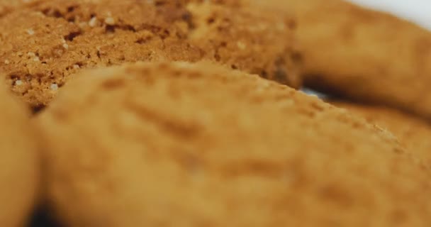 Blick von oben auf die Kekse, die sich vor der Kamera auf dem weißen Hintergrund drehen. Nahaufnahme. Makroschießen — Stockvideo