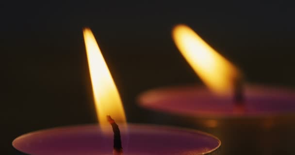 Macro shooting of the candles fire burning brightly in the dark. Close up — Stock Video