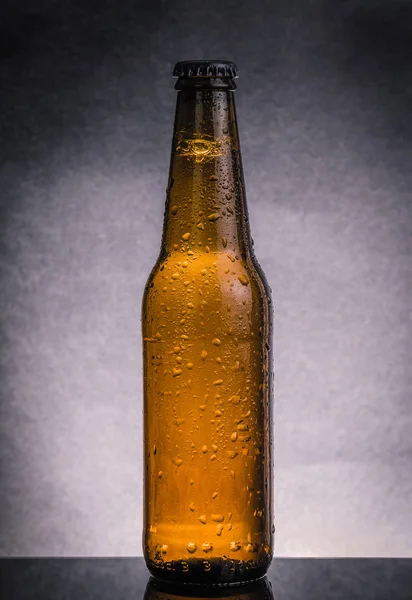 Fresh cold beer ale bottle with drops and stopper — Stock Photo, Image