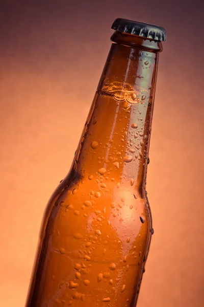 Fresh cold beer ale bottle with drops and stopper — Stock Photo, Image