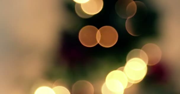 Close up of golden abstract blinking blurred Christmas tree lights bokeh on gold warm background, festive holiday — Stock Video