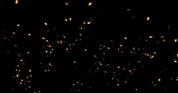 confettis dorés paillettes métalliques, mouvement d'animation sur fond noir 