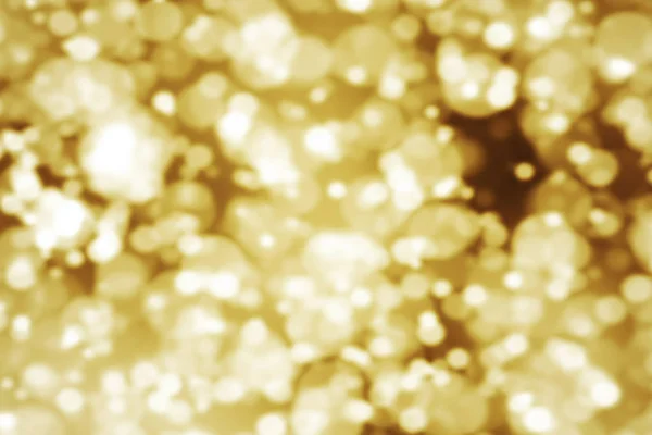 Abstract gold glow glittering particles bokeh sparkle effect, event festive holiday happy new year — Stock Photo, Image