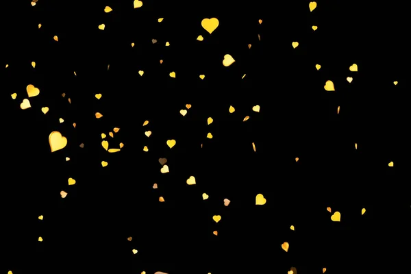 Valentine day gold hearts shape flowing on black background, holiday festive valentine day love — Stock Photo, Image