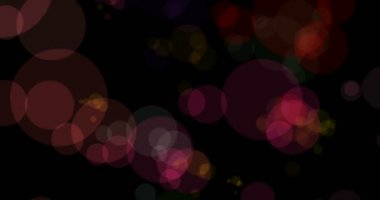 siyah arka plan üzerine akan Noel renkli parçacıklar bokeh soyut, tatil Noel şenlikli