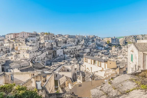 Panoramic view of typical stones (Sassi di Matera) near gravina of Matera UNESCO European Capital of Culture 2019 on blue sky — Stock Photo, Image