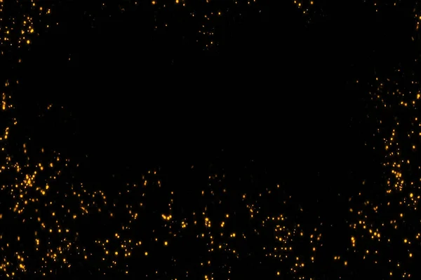 Frame of golden glitter sparkle bubbles particles stars on black background, event festive happy new year holiday — Stock Photo, Image