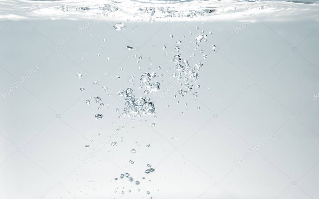 fresh fizzy water in the glass with bubbles background, close up view, health, diet nutrition 