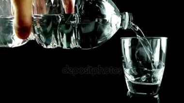 içme cam şişe siyah arka plan üzerine aracılığıyla kabarcıkları ile su ile doldurma, ağır çekim, beslenme ve sağlık sağlık vurdu