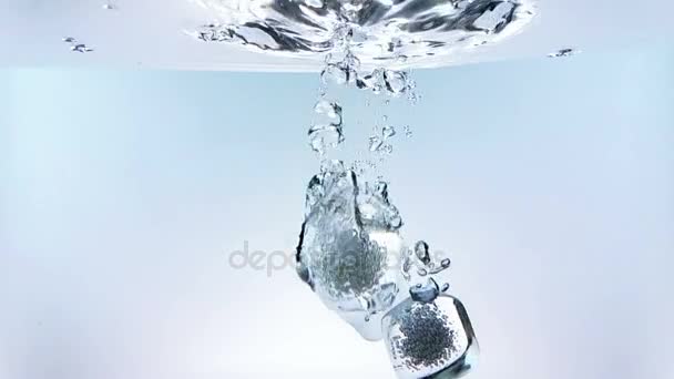 Ice cubes falling down splash into water on white background, shot slow motion, fresh drink summer time — Stock Video