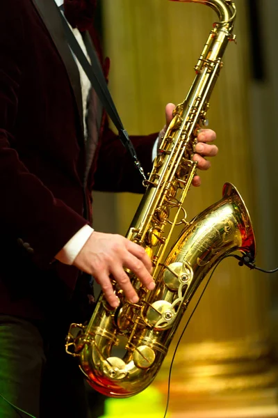 Playing saxophonist in suit — Stock Photo, Image