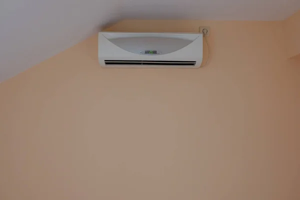 Air conditioning on the wall with a sloping roof — 스톡 사진