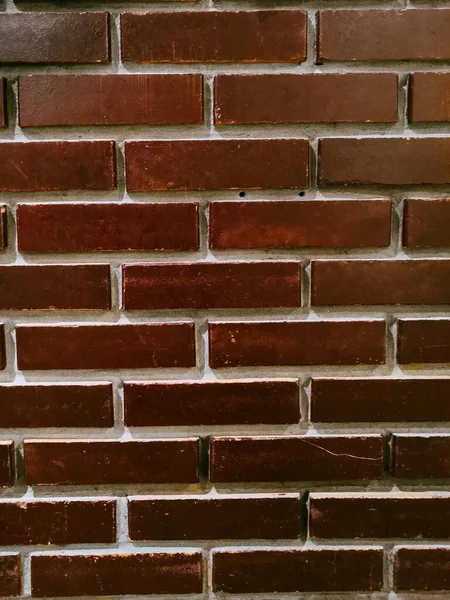 smooth wall of dark red brick. Red brick wall background.