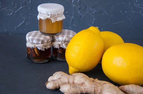 Honey, lemons and ginger on a gray background