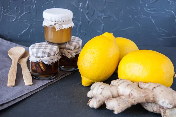 Honey, lemons and ginger on a gray background