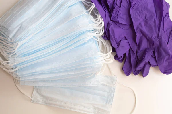 Disposable medical masks and disposable gloves on a white background