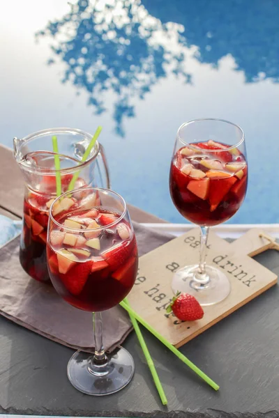 Meyveli İspanyol kırmızı şarabı (Sangria). Çilek, portakal, elma ve muz dilimleri. Havuzun yanındaki tepside.