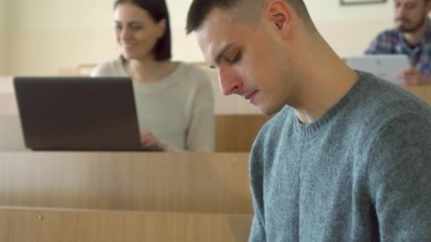 Male student reads scientific book — Stock Video