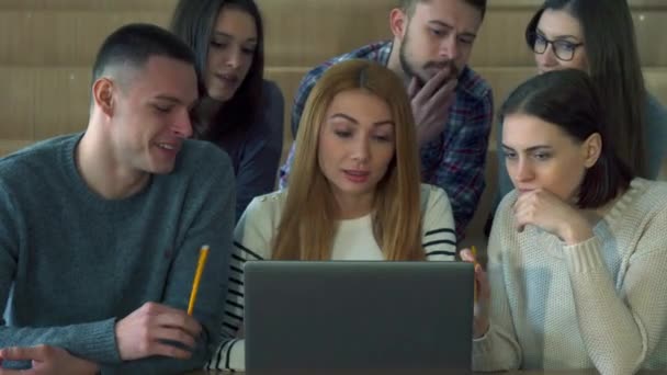Los estudiantes miran la pantalla del ordenador portátil — Vídeo de stock
