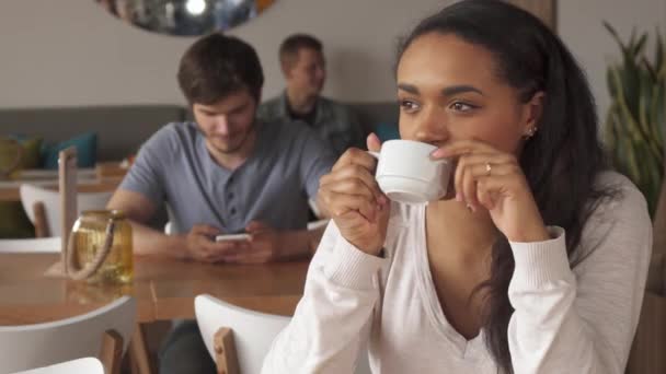 Girl enjoys the coffee drinking at the cafe — Stock Video