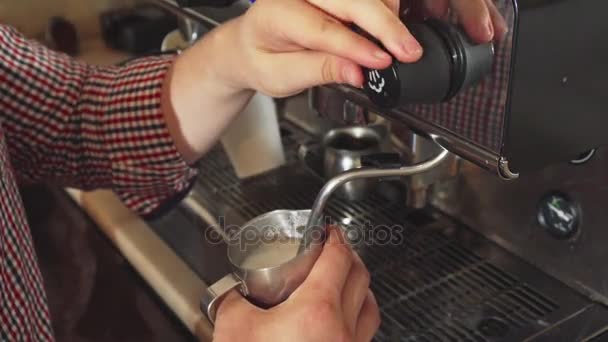 The barista makes boiled milk for cappuccino — Stock Video