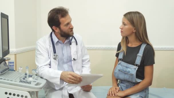 Le médecin et le patient sont assis dans le bureau pour une enquête ultrasonique — Video