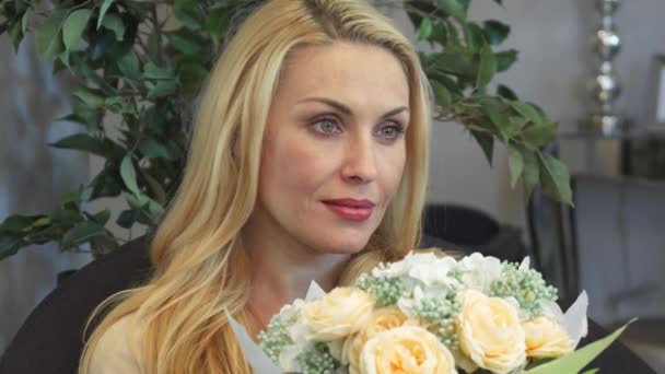 La hermosa mujer sosteniendo un ramo de flores — Vídeo de stock