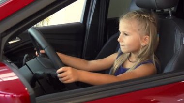 Kız bebek direksiyon direksiyon başında oturur ve sürücü için miş gibi