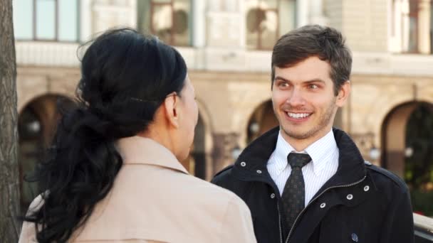 O homem sorridente tem uma boa conversa com uma mulher — Vídeo de Stock