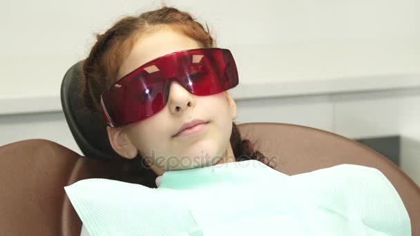 On the happy girl wearing special glasses that protect her eyes — Stock Video