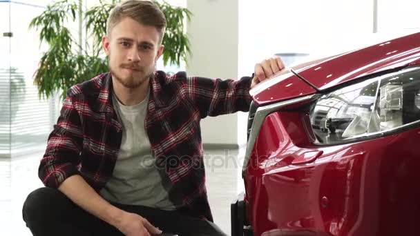 Feliz hombre guapo posando con su nuevo auto mostrando las llaves del coche a la cámara — Vídeos de Stock