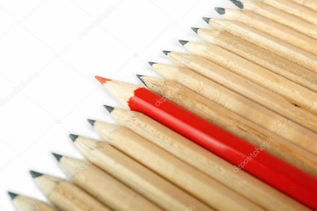 A row of rough graphite pencils with color red one