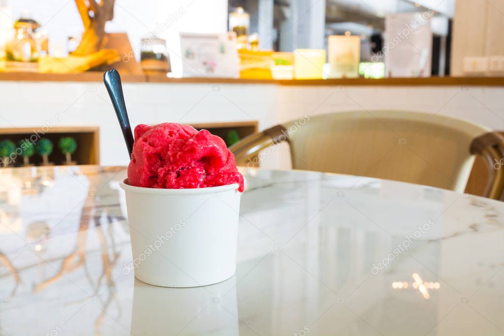 Melting Red Strawberry Icecream in White Paper Cup