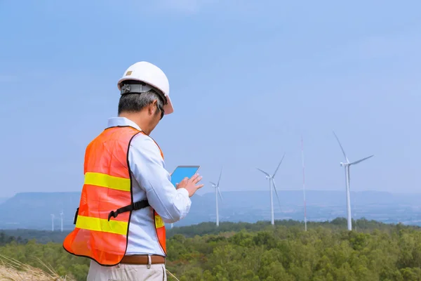 Male Architect Engineer or Businessman wear Hardhat survey Wind — Stock Photo, Image