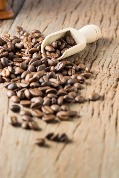 Fresh Raw Coffee Beans on Wooden Desk Table