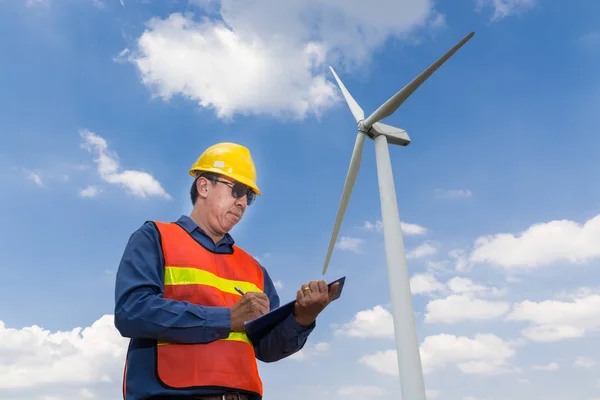 Electric Engineer writing report under Wind turbine power Genera — Stock Photo, Image