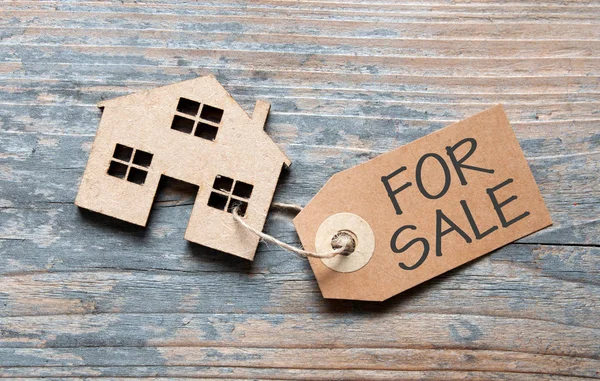 Klein huisje met voor verkoop teken — Stockfoto