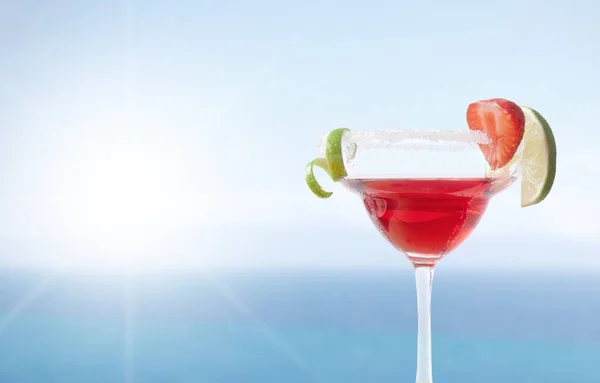 Red cocktail by the sea — Stock Photo, Image