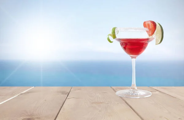 Red cocktail by the sea — Stock Photo, Image