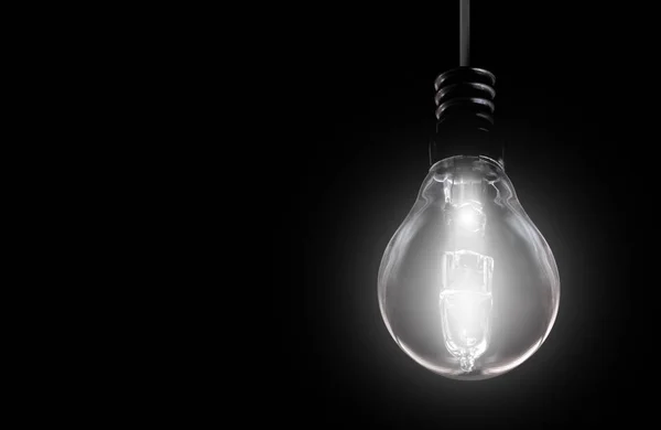 Light bulb on black background — Stock Photo, Image