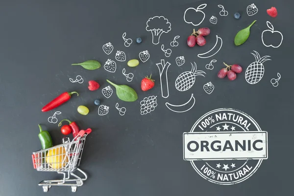 Organic groceries over a blackboard — Stock Photo, Image