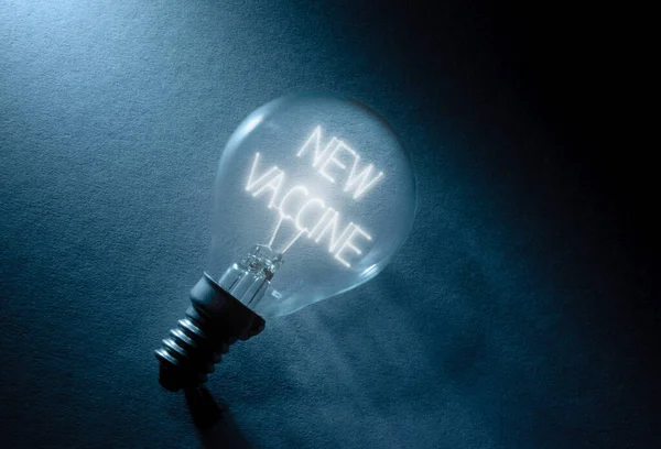 Light Bulb Illuminating Words New Vaccine — Stock Photo, Image