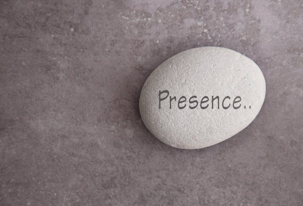 Yoga zen stone with the word presence