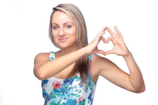 Bonita joven mujer haciendo signo de corazón en blanco —  Fotos de Stock