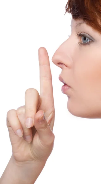 Una chica sostiene un dedo a los labios gesto en silencio —  Fotos de Stock